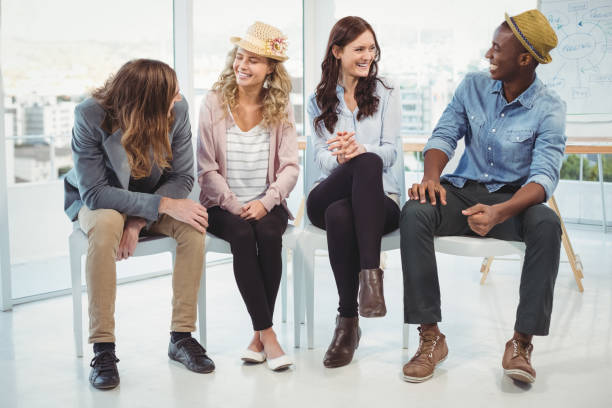 istock Smiling business people sitting on chair 670741116