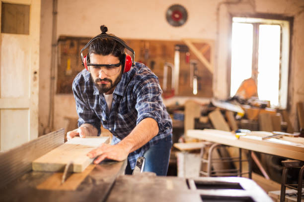 istock Carpenter cutting wooden plank 670741160