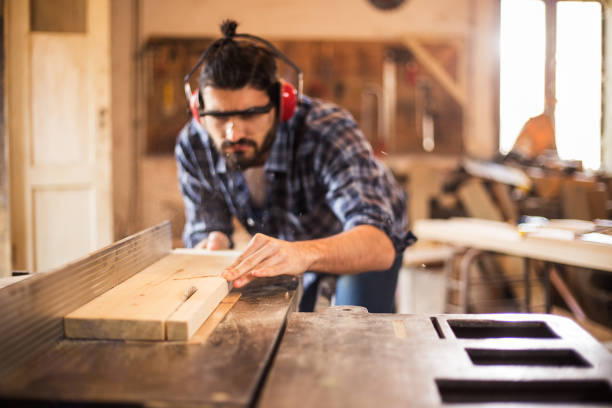 istock Carpenter cutting wooden plank 670743782