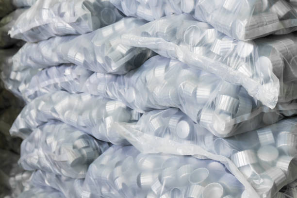 istock gray plastic bottle caps in plastic bag 670744460