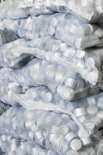 istock gray plastic bottle caps in plastic bag 670744508