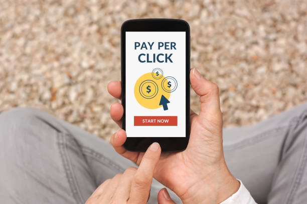 istock Hands holding smart phone with Pay Per Click concept on screen 670747838