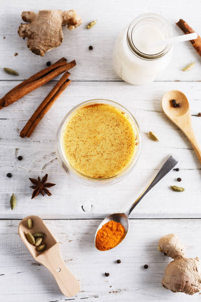 istock Top view image of turmeric latte over white wooden table 670749174
