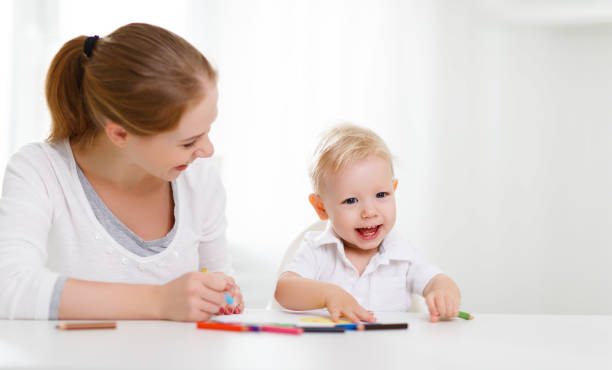 istock Mother with baby son with colored pencils 670752646