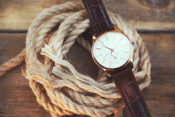 istock elegant  watch on rope on wooden  background 670752784