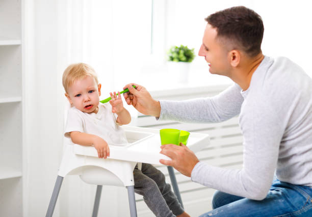 istock Father feeds the cry baby son 670755330
