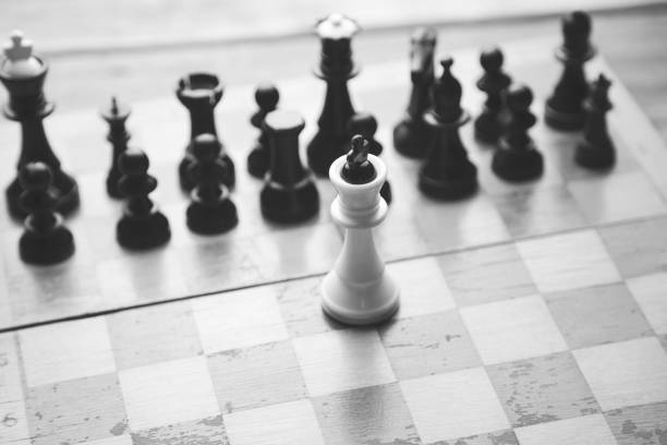 istock Fallen king pieces surrounded by the other color chess pieces 670755672