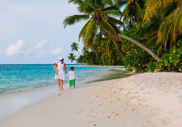 istock mother with little son and daughter walk on beach 670756256