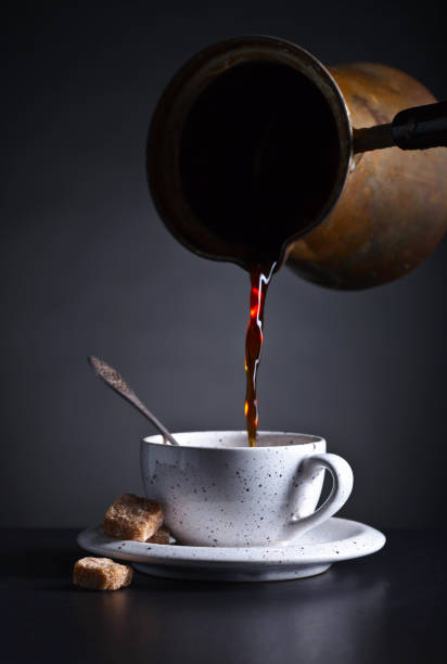 istock Fresh hot  coffee is poured into the Cup . 670761646