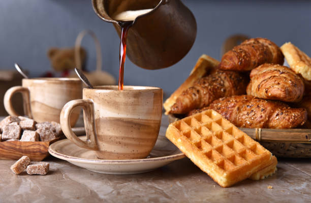 istock Breakfast with black coffee, freshly baked waffles and croissants 670761704
