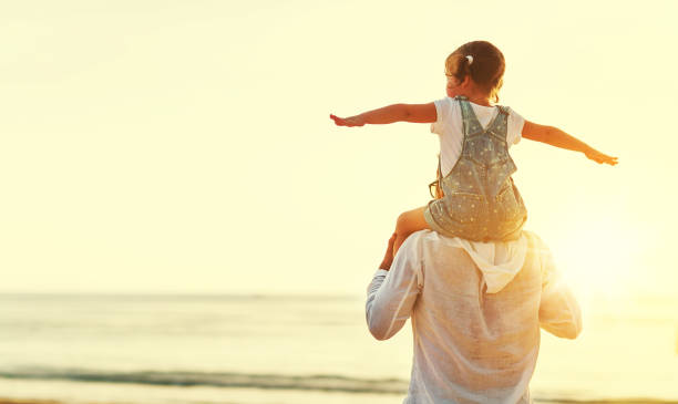 istock father's day. Dad and child daughter playing together outdoors on a summer 670761776