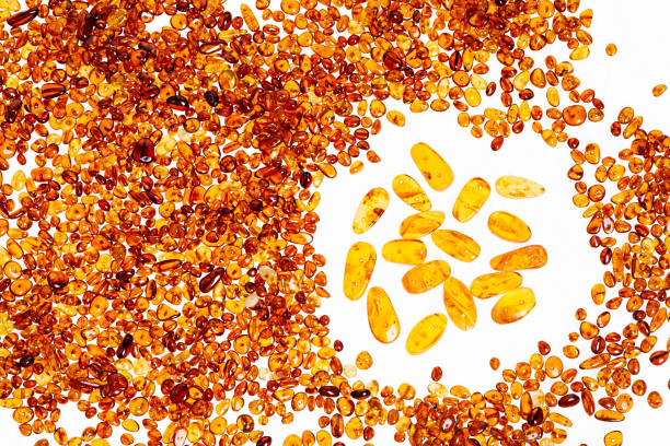 istock Yellow amber stones on a white background. 670762884