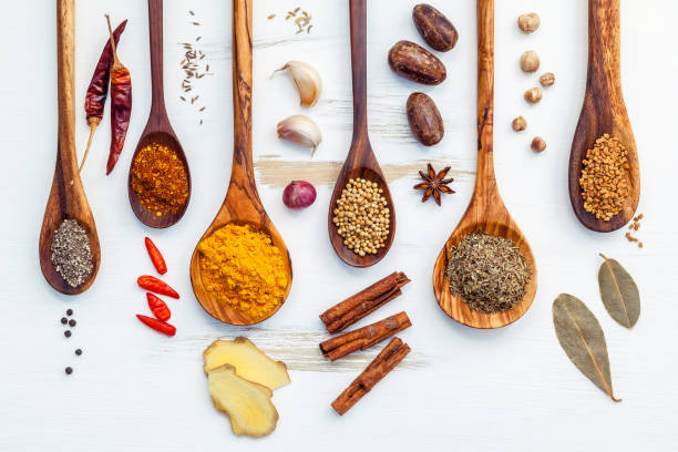 various of indian spices and herbs in wooden spoons. flat lay of spices ingredients chili ,paprika ,peppercorn, dried thyme, cinnamon,star anise and curry powder on the shabby wooden. - ginger root ingredient nature imagens e fotografias de stock