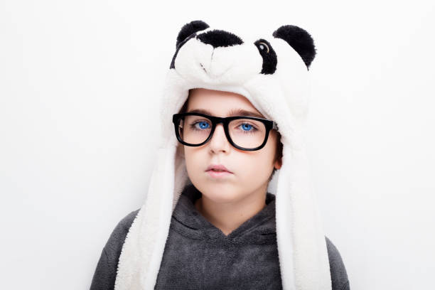 Handsome boy is wearing eyeglasses and panda hat.