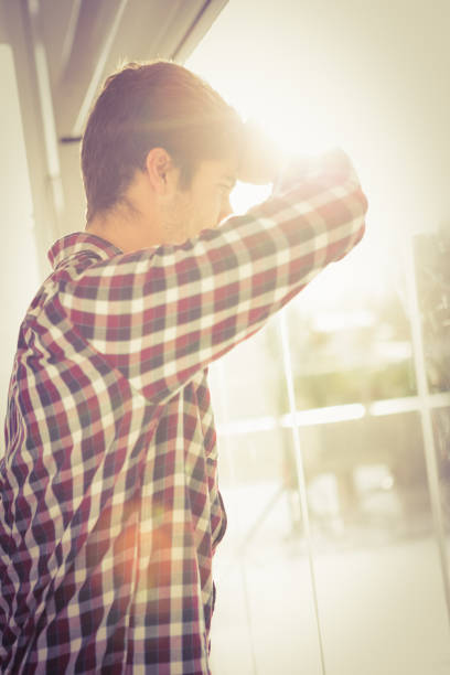 istock Low angle view of hipster looking through window 670775758