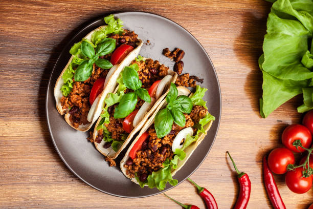 istock Mexican tacos with minced meat, beans and spices 670785798