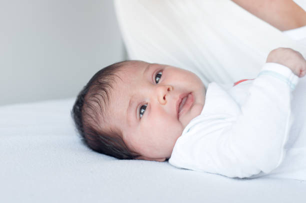 istock Newborn baby lies, and looking around. 670786442