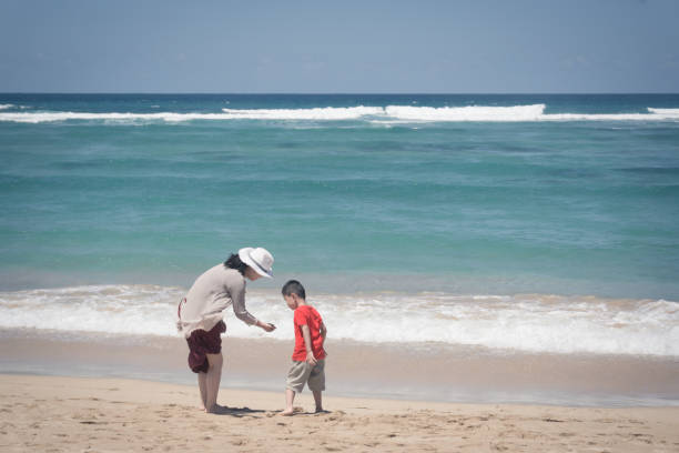 istock Mother and son playing at beach 670792414