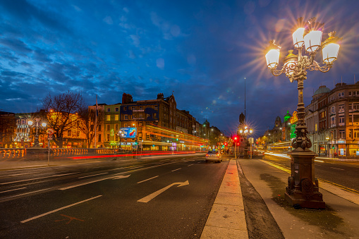 Dublin, Ireland - 8 Jan 2017: Evening traffic in the city center, Dublin. Traffic lights at embankment of Liffey River