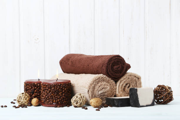 istock Towels with candles and soap on white wall paneling background 670793780