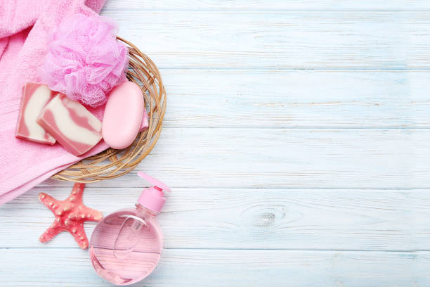 istock Pink towels with soap and wisp on white wooden table 670796164