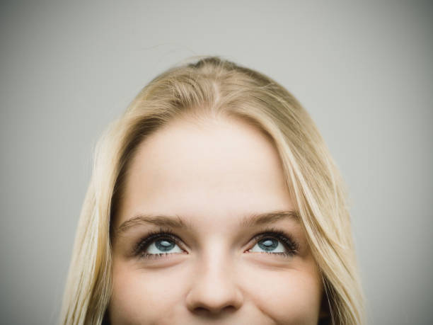 istock Excited woman smiling against gray background 670796256