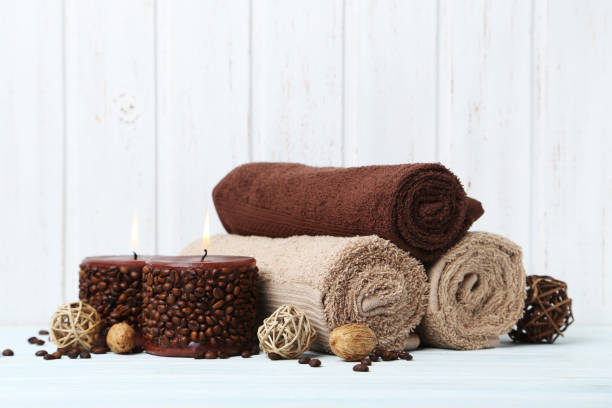istock Towels with candles on white wall paneling background 670796324