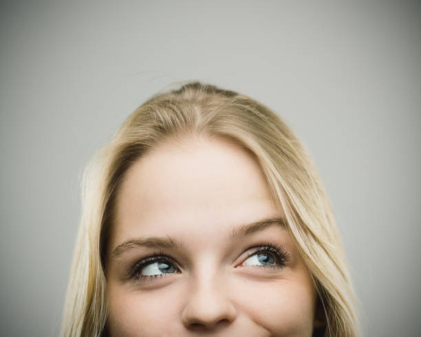 istock Excited woman smiling against gray background 670796420
