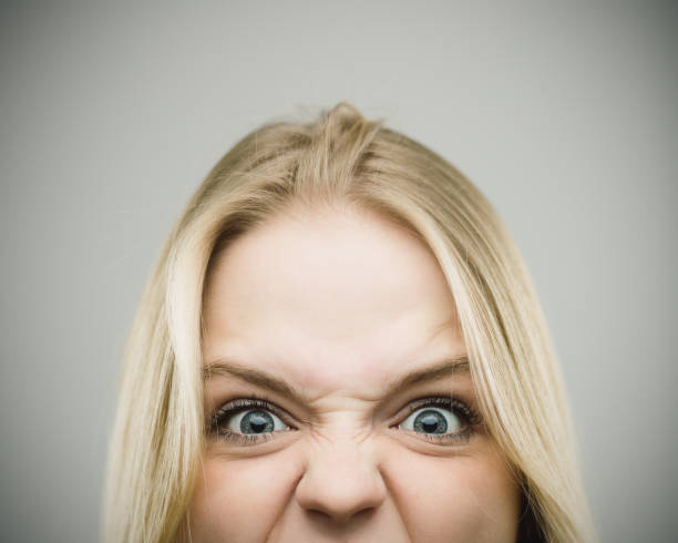 istock Furious woman screaming against gray background 670796542