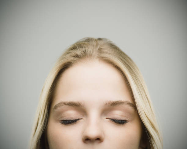 istock Relaxed woman smiling against gray background 670796646