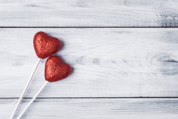 istock Red hearts on white wooden background with copy space 670799268
