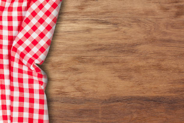istock Checkered tablecloth on wooden background. Use for background 670812304