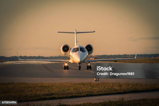 Business Jet Taxiing Along The Runway Stock Photo - Download Image Now - Corporate Jet, Passenger, Sunset