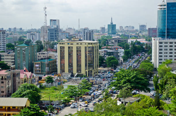 tuk tuk drivers and other road users travel around the port city of lagos - áfrica ocidental imagens e fotografias de stock