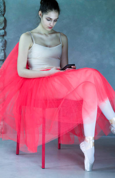 istock beautiful ballet dancer sitting in relax with phone 670815362