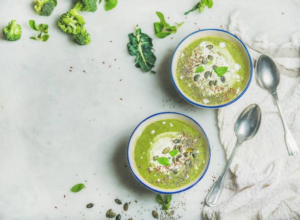 istock Broccoli cream soup with mint and coconut cream, copy space 670817836