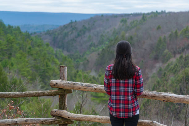 istock Woman enjoying the view of the mountain range 670817896