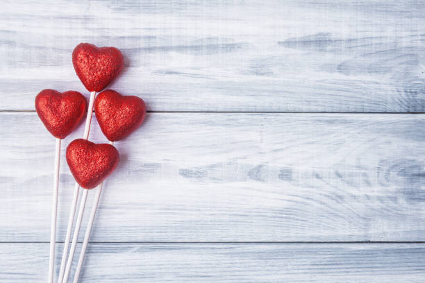 istock Red hearts over light blue wooden background 670818082