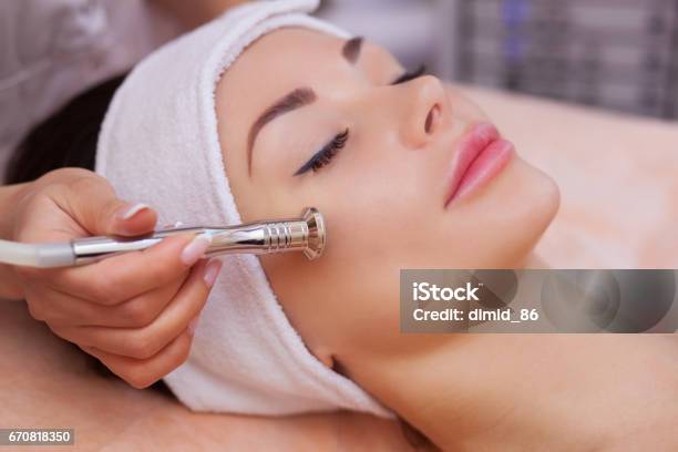 Doctorcosmetologist Makes The Procedure Microdermabrasion Of The Facial Skin Of A Beautiful Young Woman In A Beauty Salon Stock Photo - Download Image Now