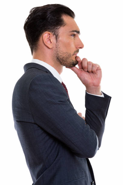 Profile view of young handsome businessman thinking vertical shot