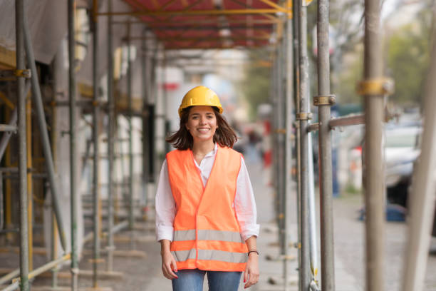 istock Young engineer wearing protective workwear among scaffolding on construction site 670825074