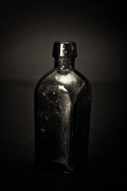istock Old colourful bottles against a dark background 670825238