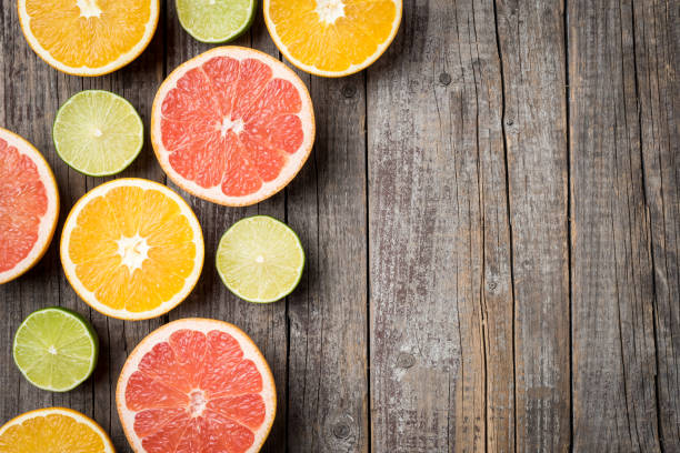 istock Colorful fruits background with orange, grapefruit and lime halves. 670835686
