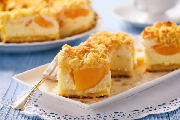 istock Cheesecake with peaches on blue wooden background. 670839984
