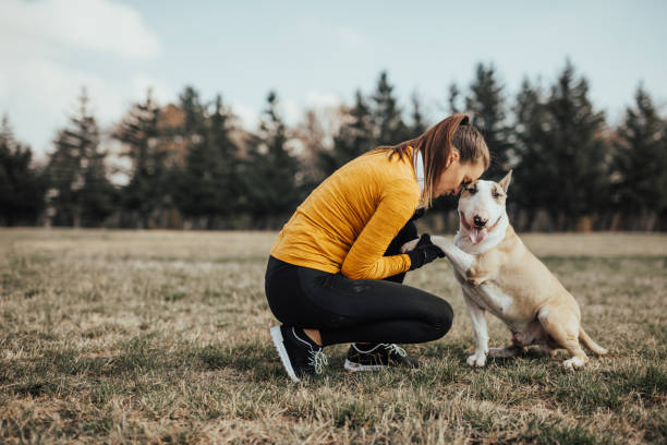 istock young woman hugging her dog 670848596