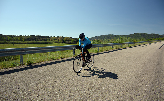 cyclist training on a lonely road during the day