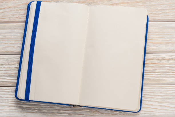istock Open notebook with blue cover on a wooden background 670852056