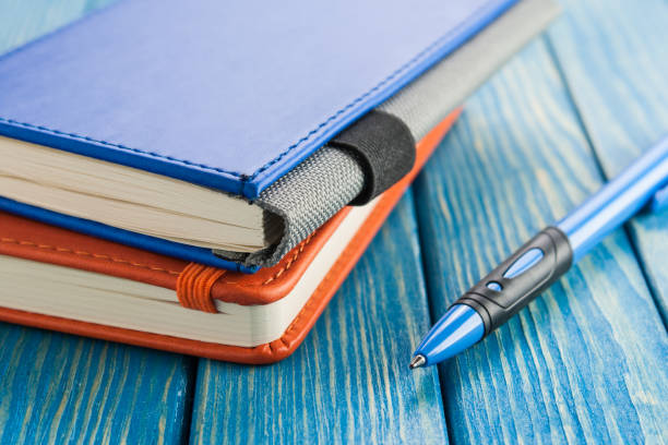 istock Stationery, notepad and pen on a dark background 670852302