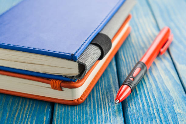 istock Stationery, notepad and pen on a dark background 670852604