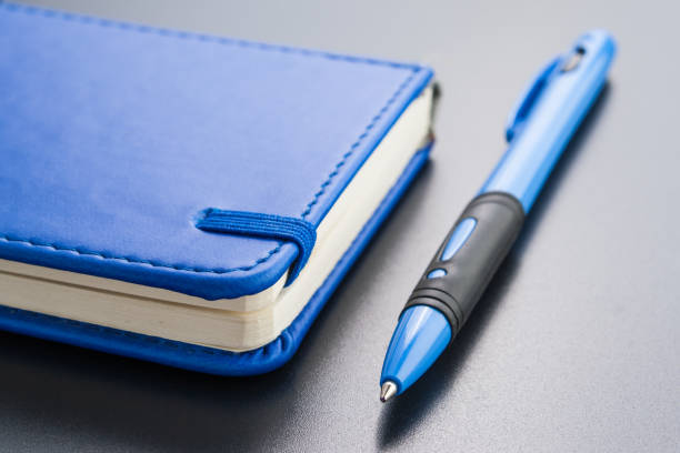 istock Stationery, notepad and pen on a dark background 670856884
